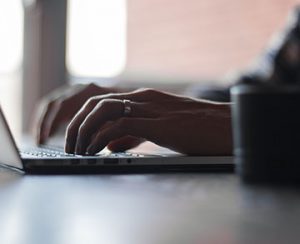Man typing on a laptop