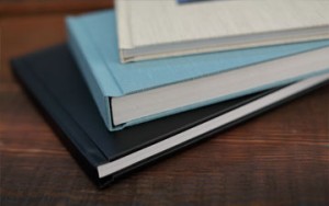 3 wedding photo albums on a coffee table