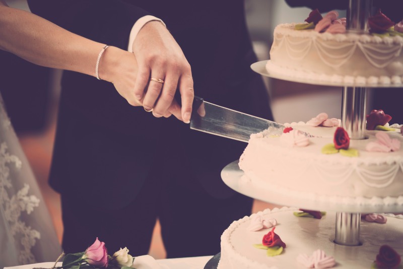 bride and groom cutting cake taken with sony mirrorless camera