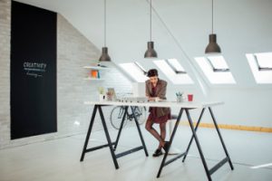 female photographer standing at a desk