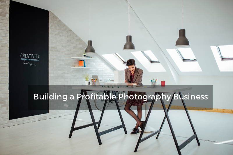 female photographer standing at desk