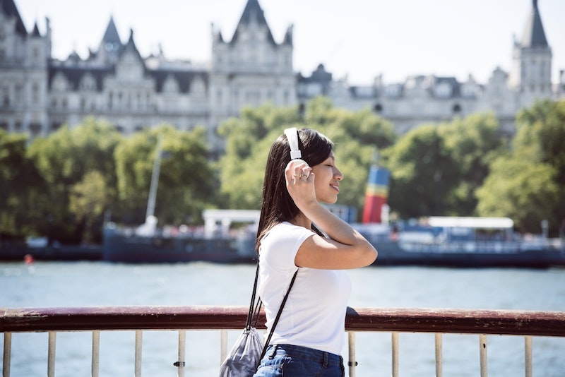 candid photo of woman walking along river