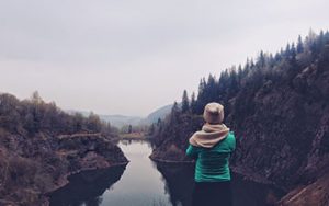 Person looking out over a river