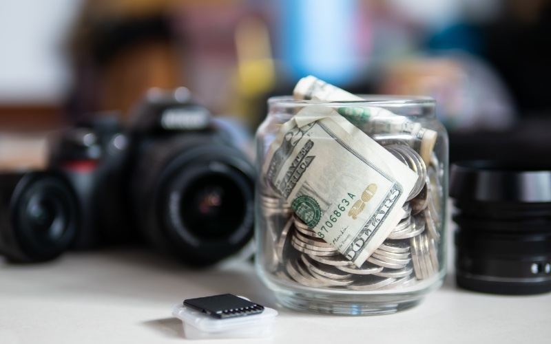money jar with camera in background
