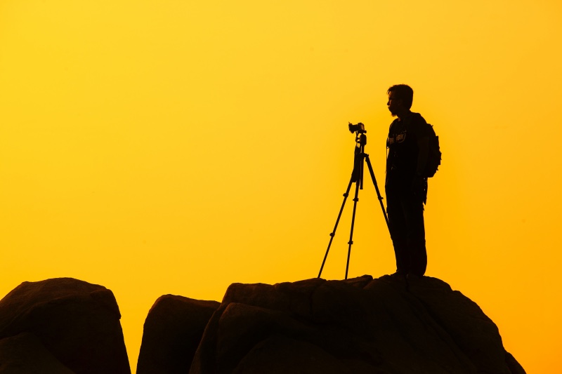 man photographing landscape