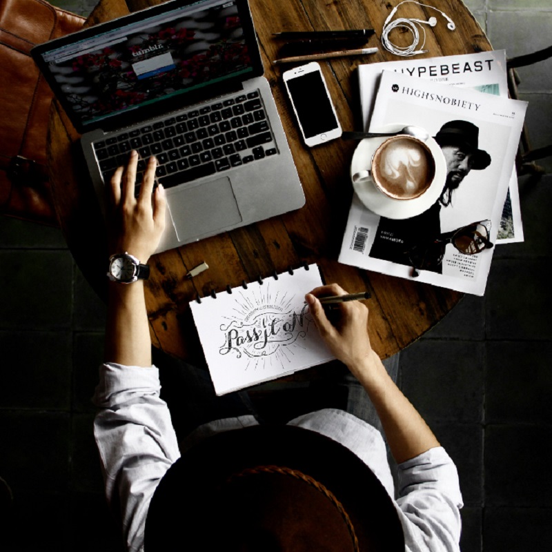 Woman drinking coffee working at a desk