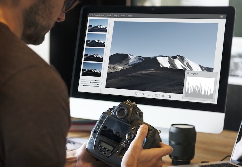 man editing photos at a computer