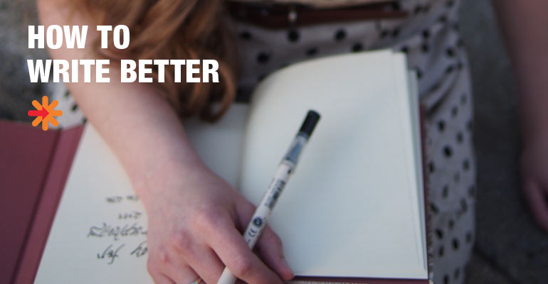 Close up of a photographer writing with a pen