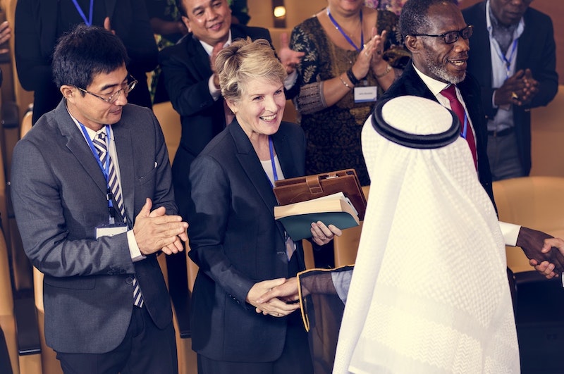 woman shaking hands at a conference
