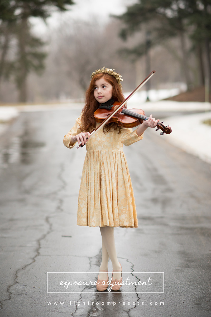 Red-headed girl playing the violin in the street