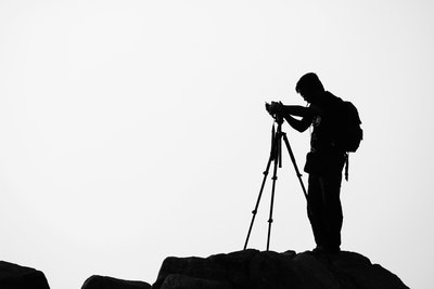 photographer setting up a travel tripod