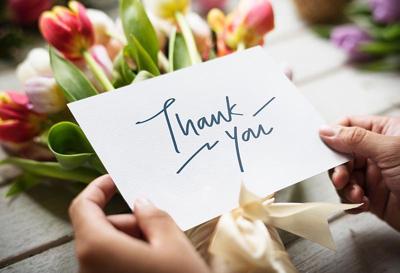 thank you card in front of flowers